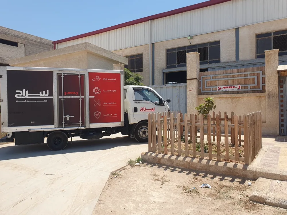 Branded Sarraj Kitchens delivery truck at the workshop gate